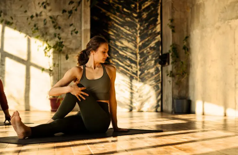 Woman doing floor stretching before working out. Understanding the Magic of Bowen Technique. Osteopath Carindale. Osteopath Support Hip or Pelvic Discomfort. Brisbane Livewell Clinic
