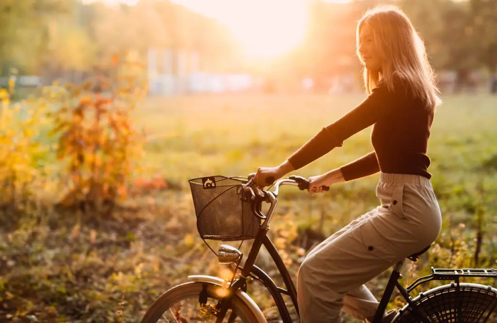 Woman riding a bicycle in the park. Cliical Hypnotherapy Northgate. Brisbane Livewell Clinic