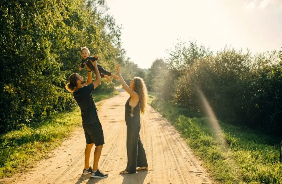 Couple carrying their child while standing on the dirt road. Counselling Carina. Brisbane Livewell Clinic