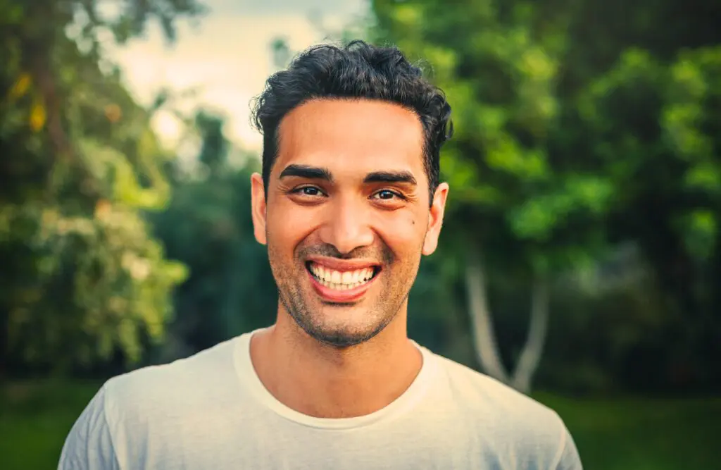 A portrait of a man smiling at the park. Naturopathy Wavell Heights. Addiction Hypnotherapy. Osteopath South Brisbane. I Feel Too Much Too Deeply. Is Osteopathy covered by Private Health Insurance. Brisbane Livewell Clinic