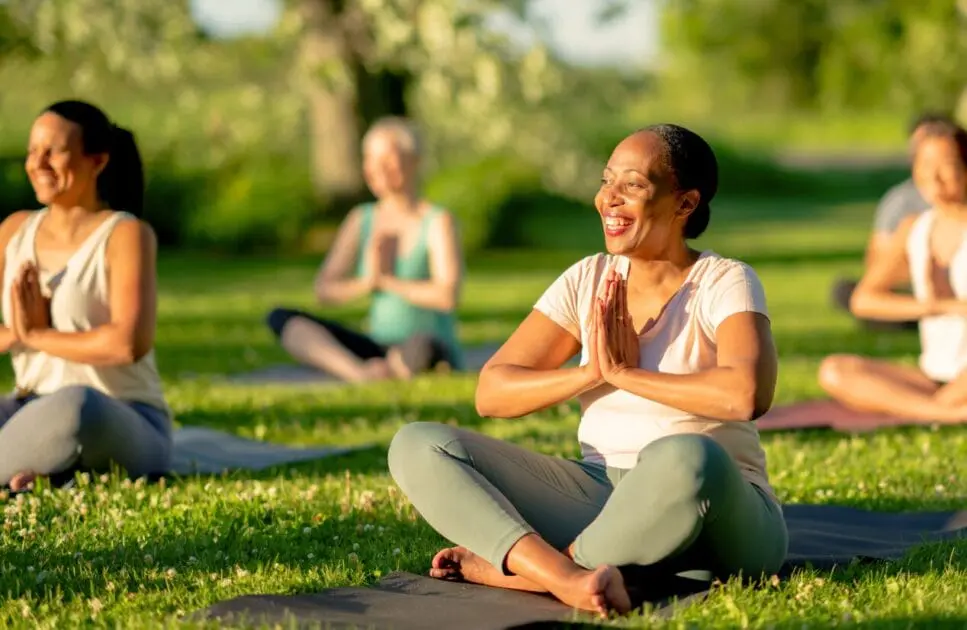 A group of people practicing yoga outdoors. Naturopathic Anxiety Medication. Brisbane Livewell Clinic