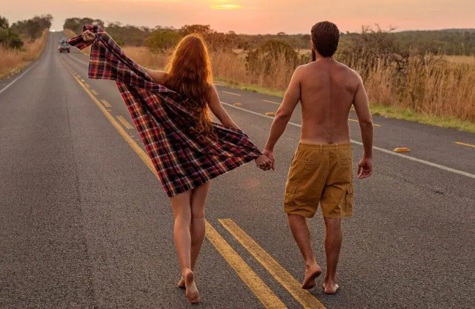 Barefoot couple walking hand in hand down a rural road at sunset. Marriage Counselling. Brisbane Livewell Clinic
