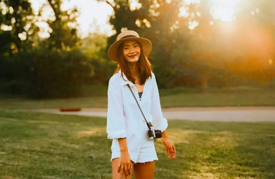Woman smiling and enjoying outdoors. What Causes Painful Periods. Osteopathy for Hip Pain and Pelvic Imbalance. Brisbane Livewell Clinic