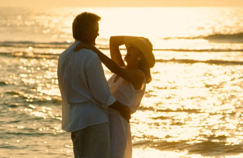 Romantic couple embracing on a beach during sunset. Marriage and Couples Counselling. Brisbane Livewell Clinic