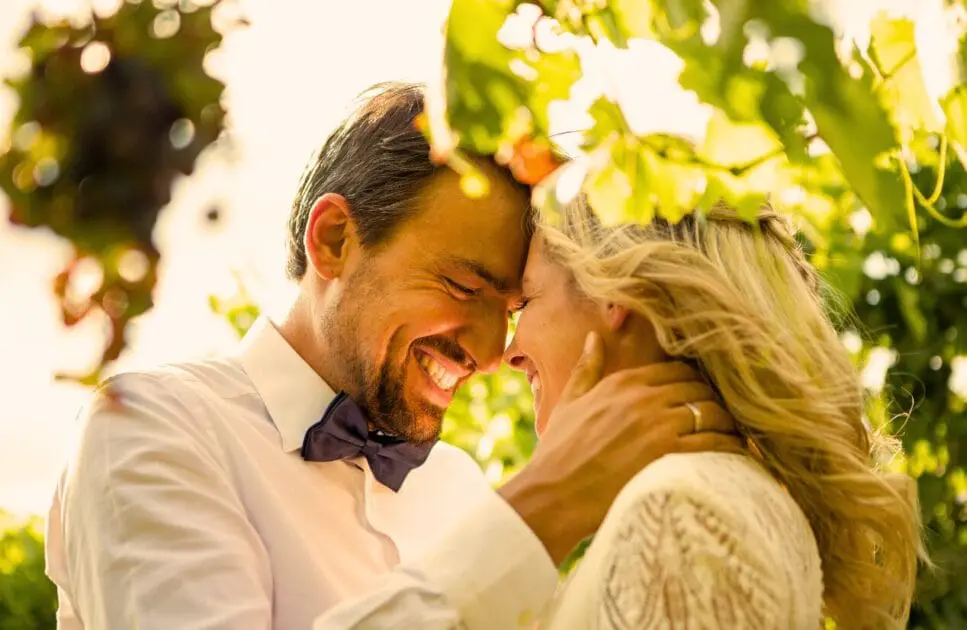 Happy couple sharing a tender moment outdoors, with their foreheads touching and smiling warmly at each other. Marriage Counselling. Brisbane Livewell Clinic
