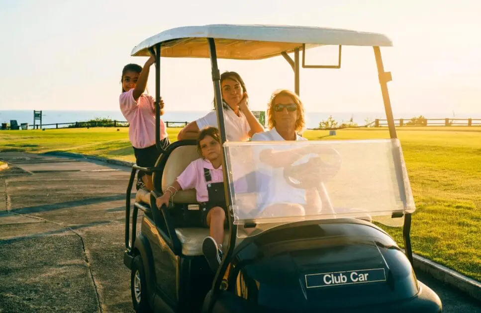 Family riding a golf cart. Counselling Services. Elbow Discomfort Osteopath. Brisbane Livewell Clinic