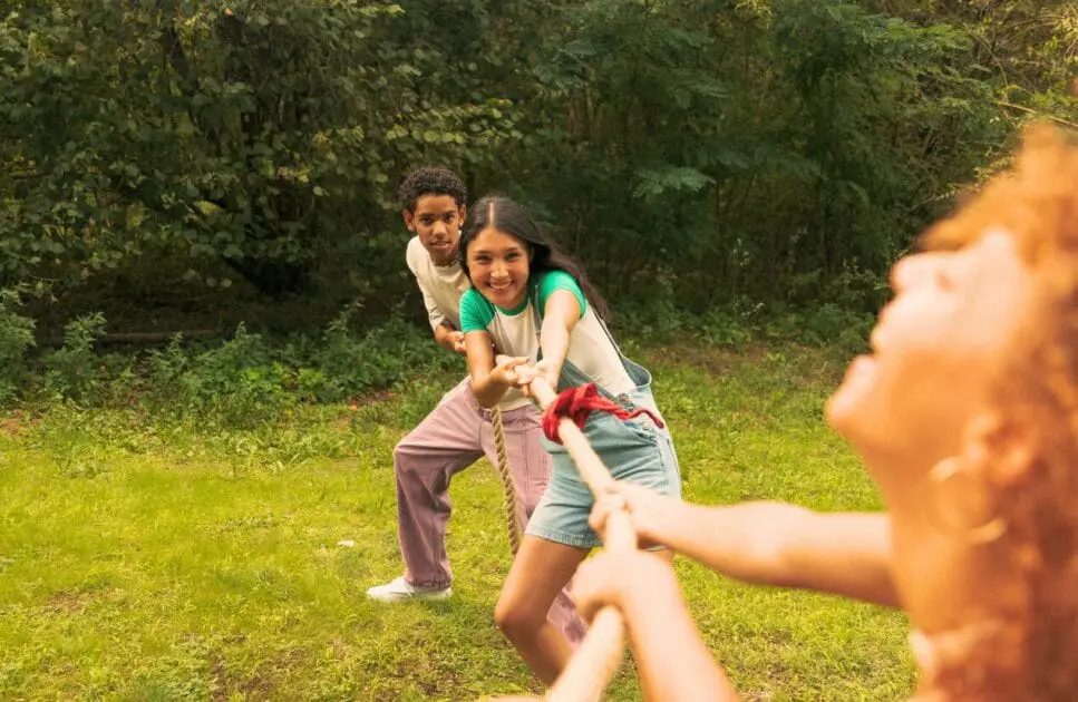 Teenage friends playing tug of war. Youth Counsellor. Brisbane Livewell Clinic