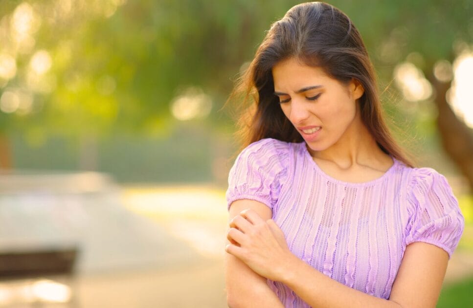 What You Need To Know About Food Intolerance 2 Woman scratching her arm. What you need to know about Food Intolerance. Brisbane Livewell Clinic