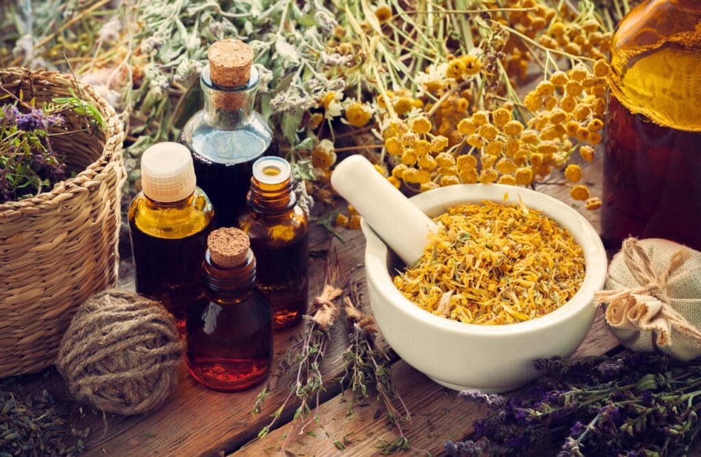 The Role of Nutrition and Naturopathy in Wellbeing 2 Bottels of herbal medicine and dried flowers. Nutrition and Naturopath. Natural Dispensary. Brisbane Livewell Clinic