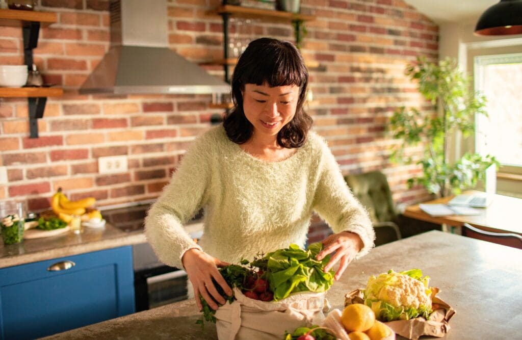 The Role of Nutrition and Naturopathy in Wellbeing 4 Woman getting the groceries out of the bag. Nutrition and Naturopathy. Acne Naturopath. Brisbane Livewell Clinic