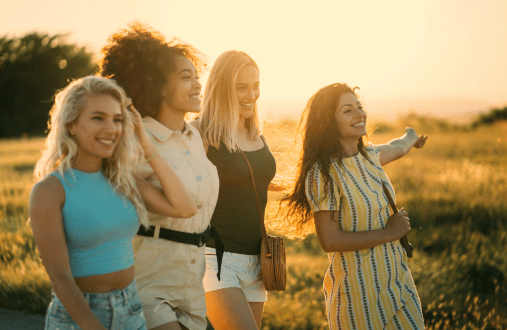 Women walking on a field during sunset. Managing Menopause. Brisbane Livewell Clinic
