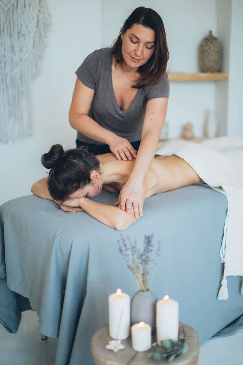 Woman Lying on Bed While Having A Massage. Full Body Massage Brisbane.