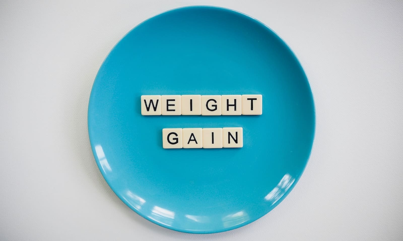 Blue and white round plate with "weight gain" written on it. Digestive Problems - Brisbane Livewell Clinic