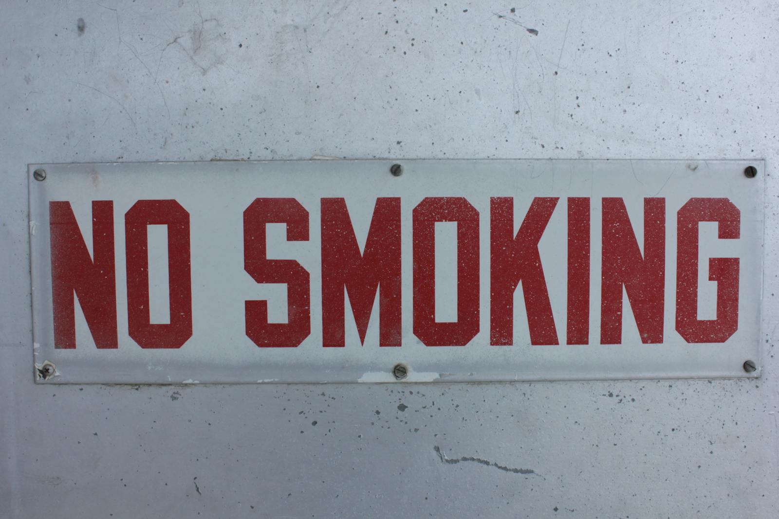 Close-up of a No Smoking Plaque on a Wall. Quit Smoking. How Much Does Hypnotherapy Cost