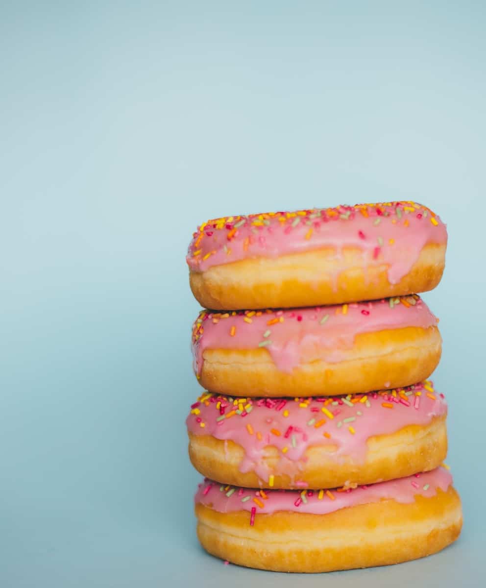 four donuts with sprinkles. Leaky gut and intestine permeability