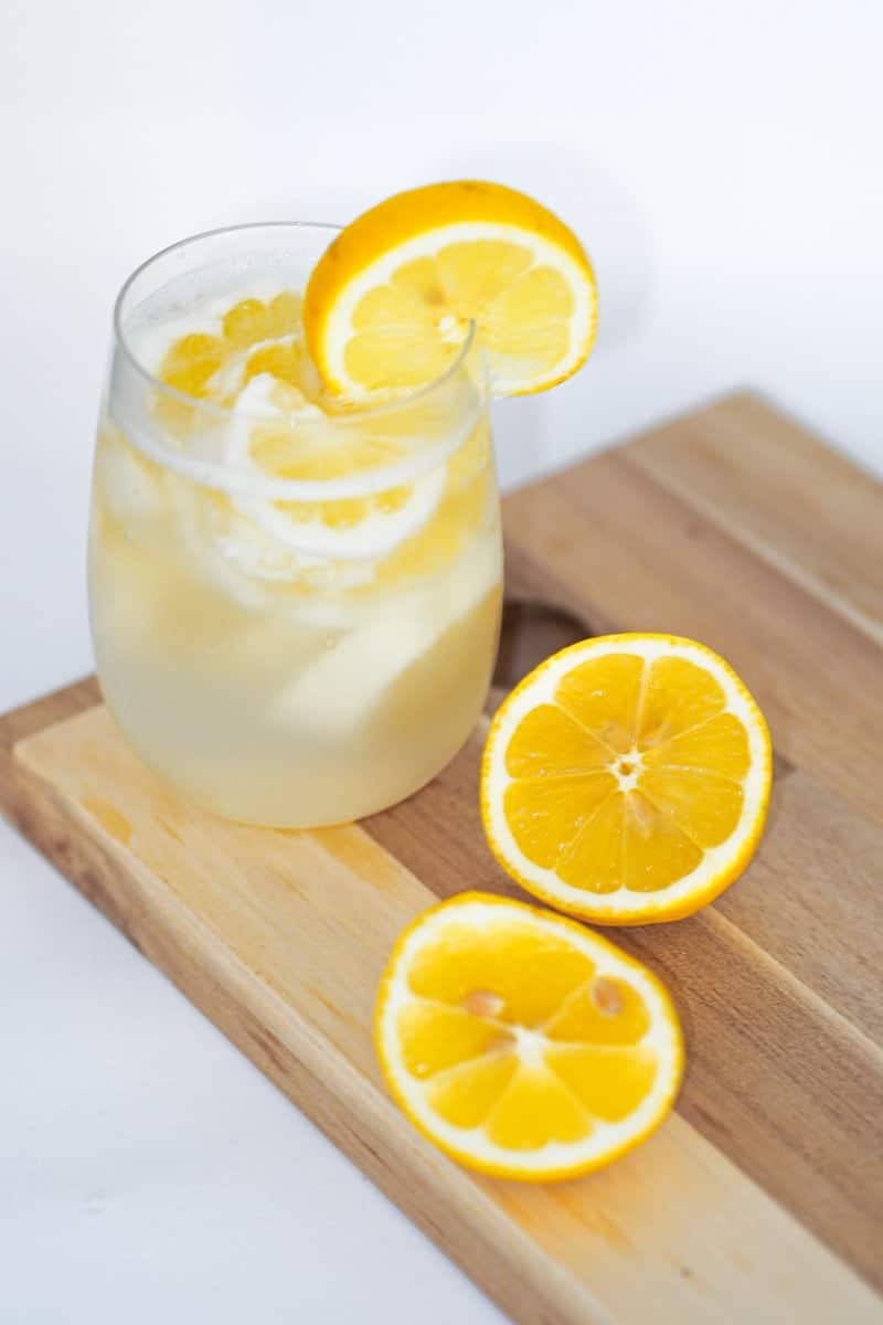 clear drinking glass with lemon juice. Lemon water for Daily rituals gut health