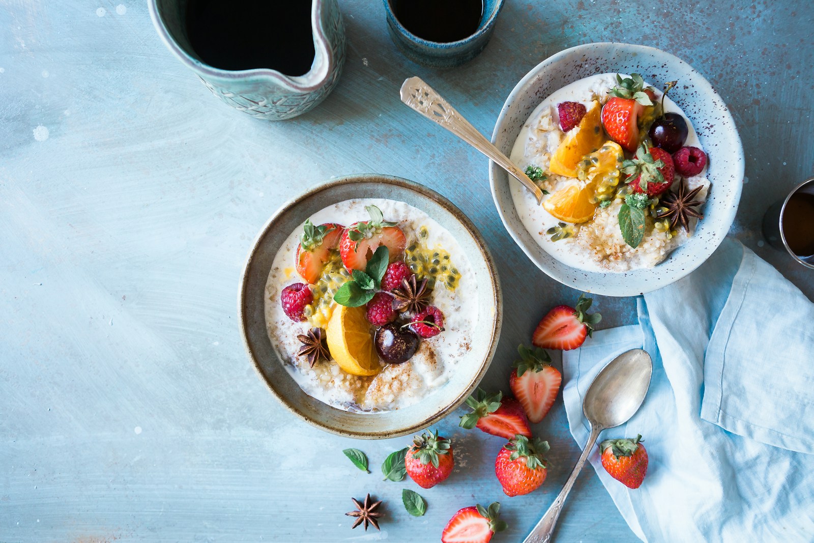 two bowls of oatmeal with fruits. Probiotic rich breakfast - daily ritual for gut health 