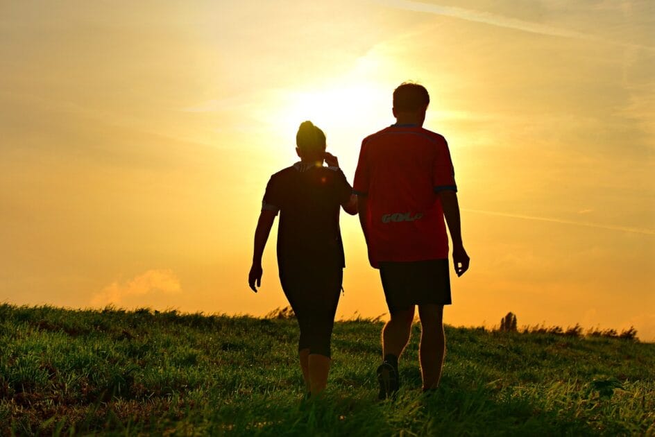 Man and Woman walking through the sunset. Natural treatment of thrush. Natural thrush relief
