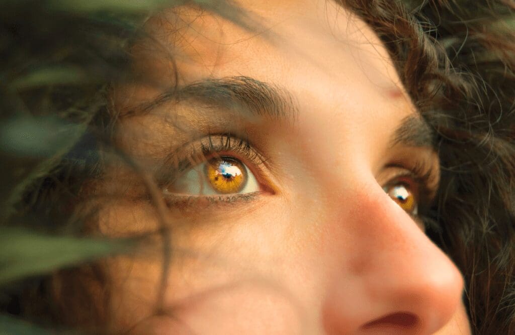 A close-up of a woman's face with clear brown eyes. Iridology. Brisbane Livewell Clinic