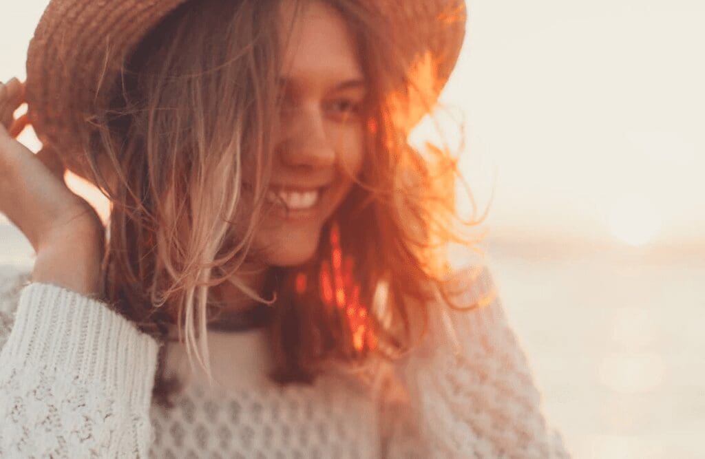 Woman wearing white sweater smiling after Hypnotherapy session. Hypnotherapy Melbourne prices. Brisbane Livewell Clinic