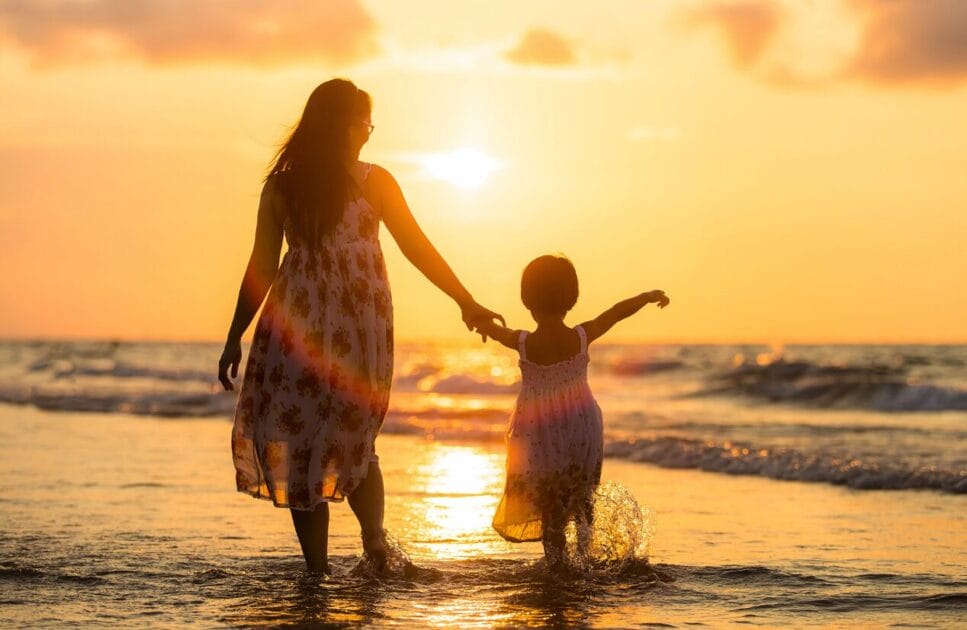 Mother and daughter walking on the beach at sunset. Genetic Methylation Test. Brisbane Livewell Clinic