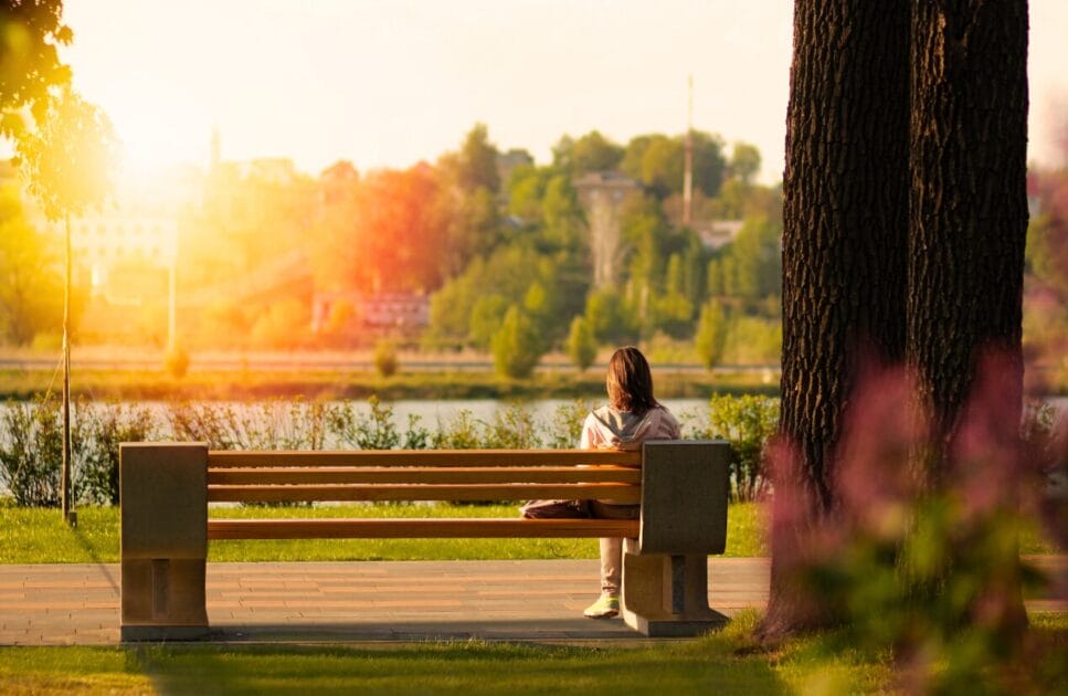 Woman sitting on a bench near the body of water. Genetic Methylation Test. Brisbane Livewell Clinic