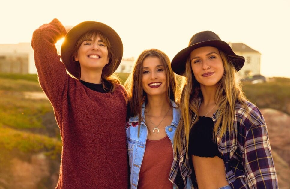 Three smiling young women are posing outdoors. Genetic Methylation Test. Brisbane Livewell Clinic