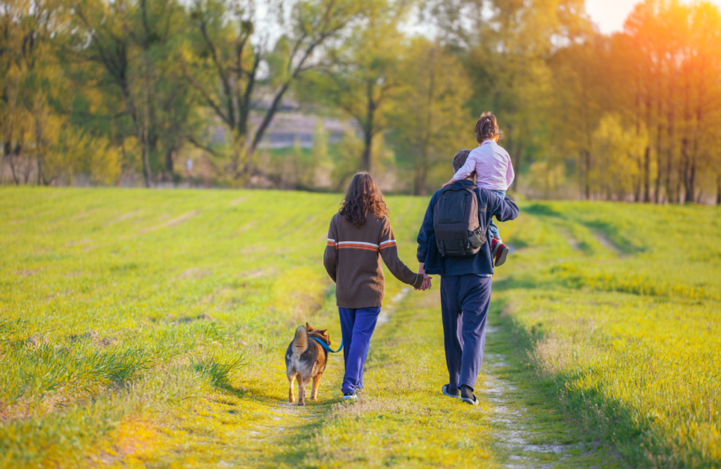Brisbane Wellbeing 1 Happy family walking together with their dog. Brisbane Wellbeing. Brisbane Livewell Clinic
