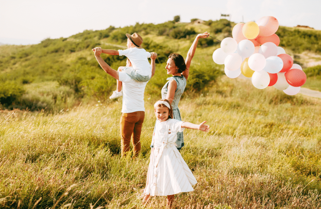 Brisbane Wellbeing 12 Family walking in the field, holding balloons. Brisbane Wellbeing. Brisbane Livewell Clinic