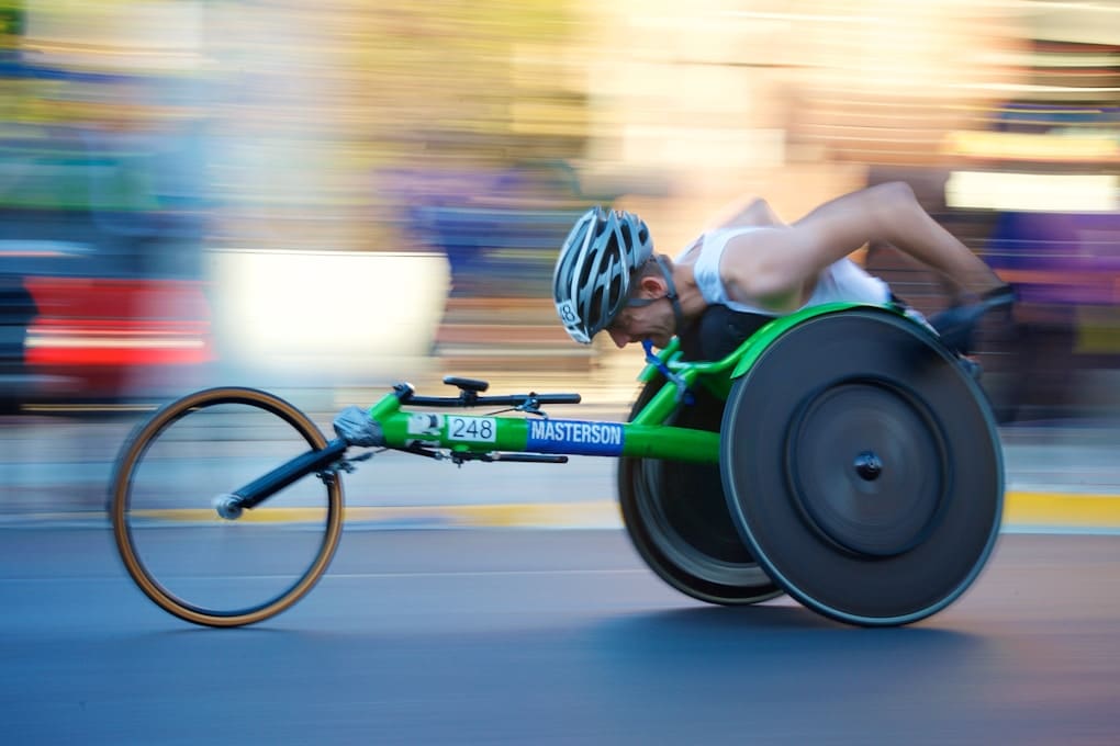 Athlete in a green racing wheelchair. Osteopath Bulimba. Glenn Strutt. Brisbane Livewell Clinic (Cannon Hill). Best Osteopath near me. Osteopathy near me